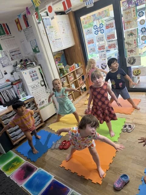 Children practising yoga together on mats at Montys Nursery